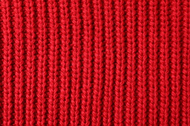 Texture of red knitted fabric as background, top view