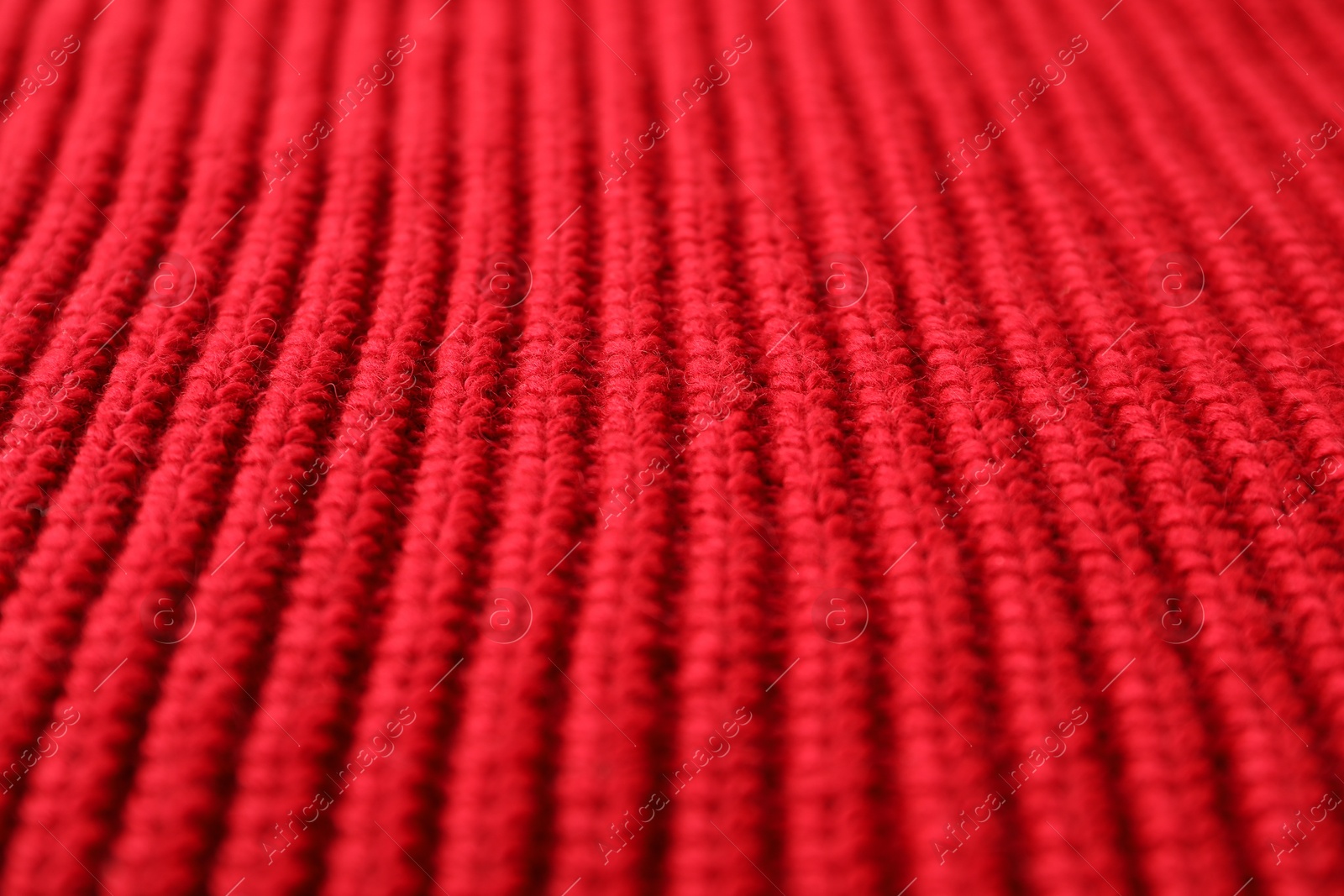 Photo of Texture of red knitted fabric as background, closeup