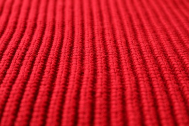 Photo of Texture of red knitted fabric as background, closeup