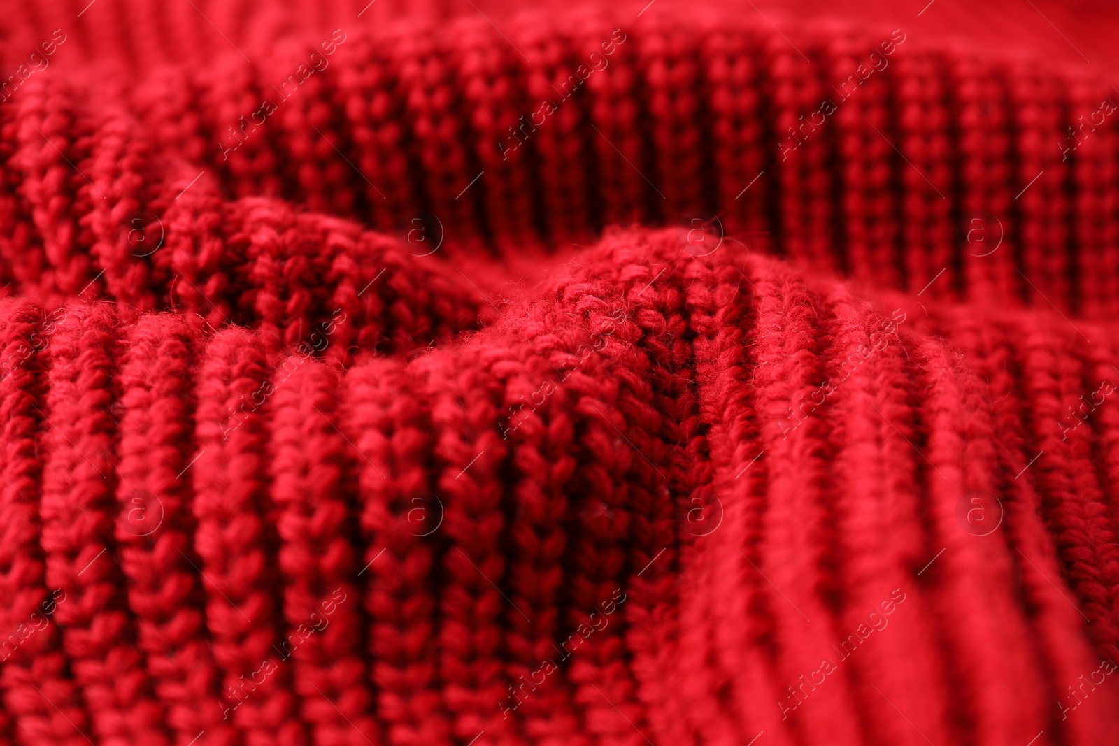 Photo of Texture of red knitted fabric as background, closeup