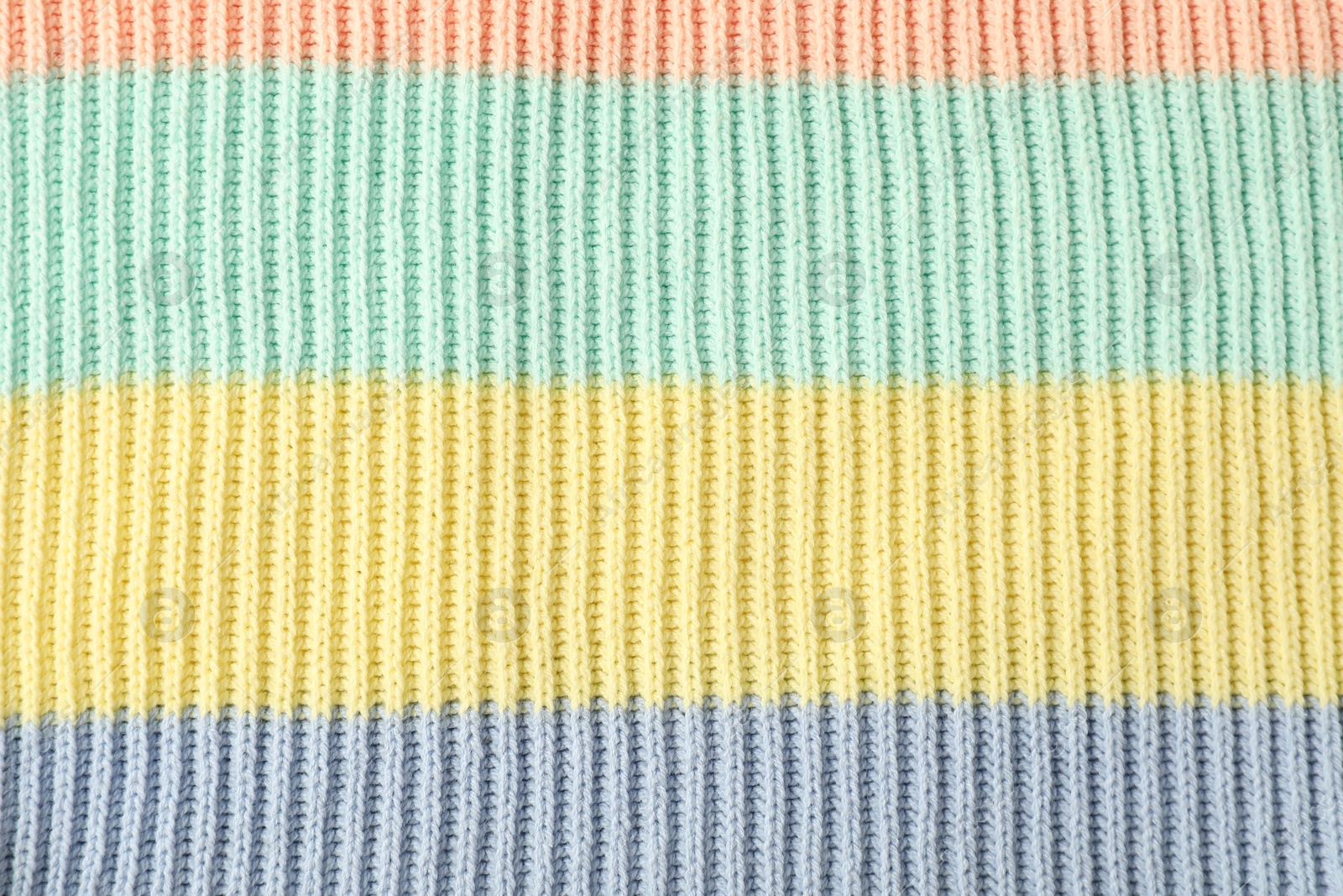 Photo of Texture of colorful knitted fabric as background, top view