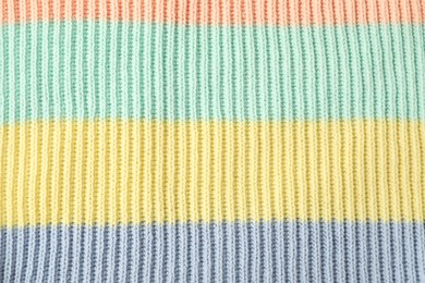 Photo of Texture of colorful knitted fabric as background, top view