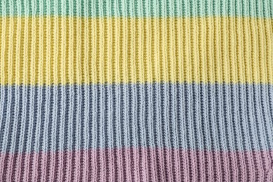 Photo of Texture of colorful knitted fabric as background, top view