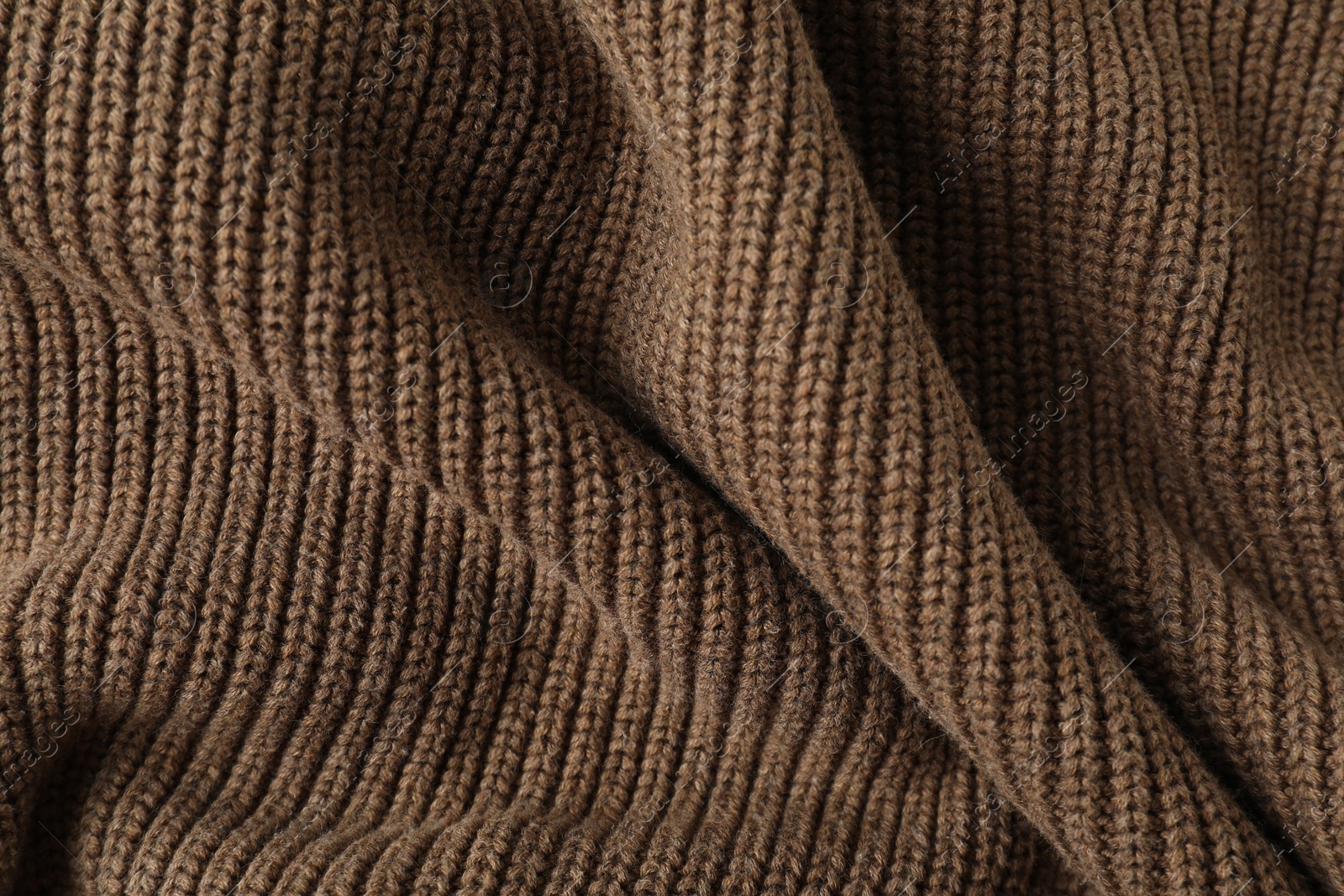 Photo of Texture of brown knitted fabric as background, top view