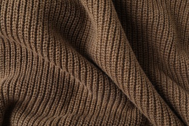 Texture of brown knitted fabric as background, top view