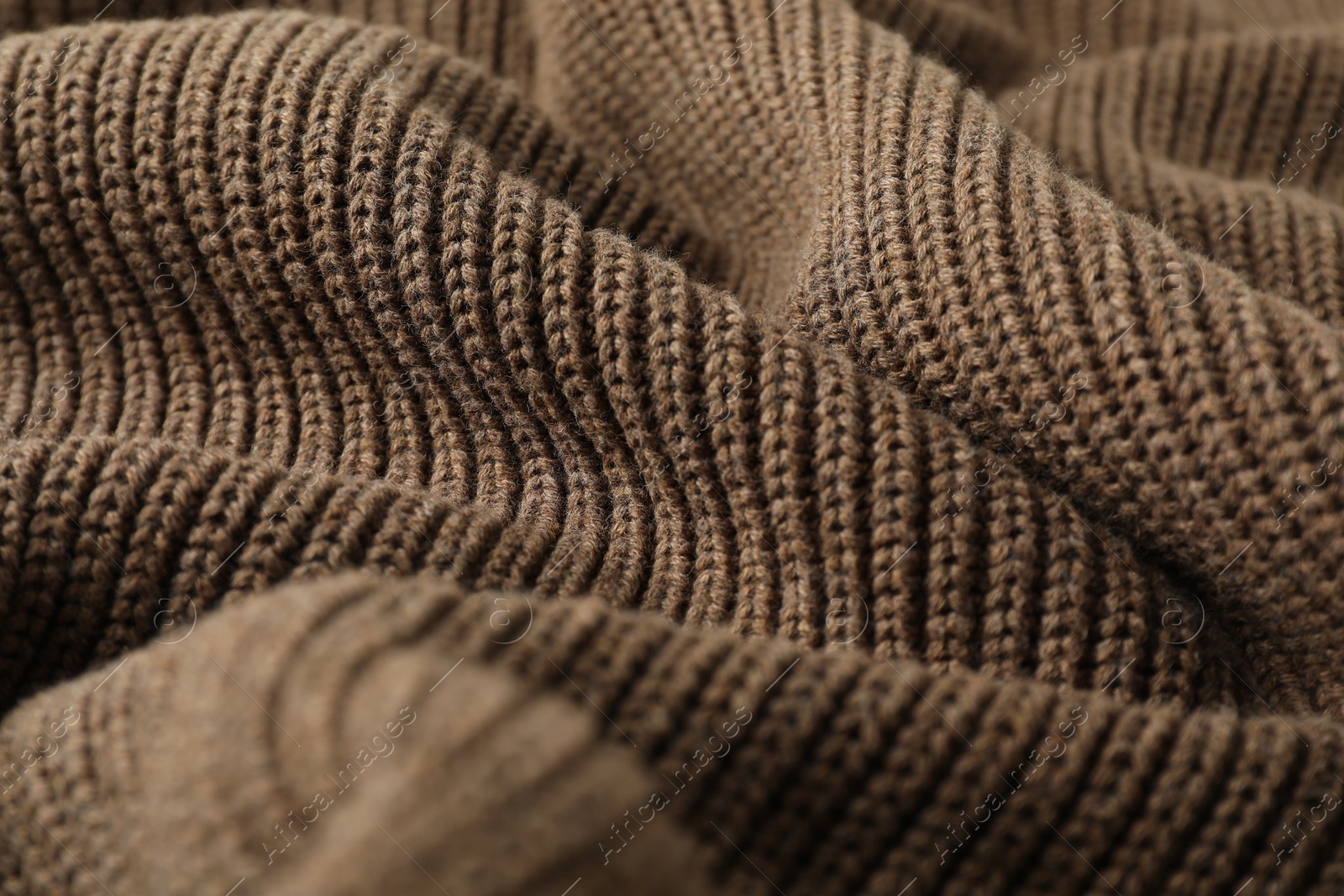 Photo of Texture of brown knitted fabric as background, closeup