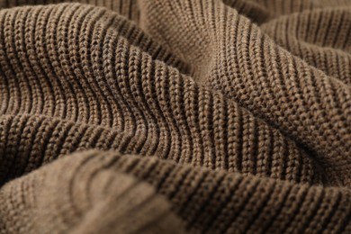 Photo of Texture of brown knitted fabric as background, closeup