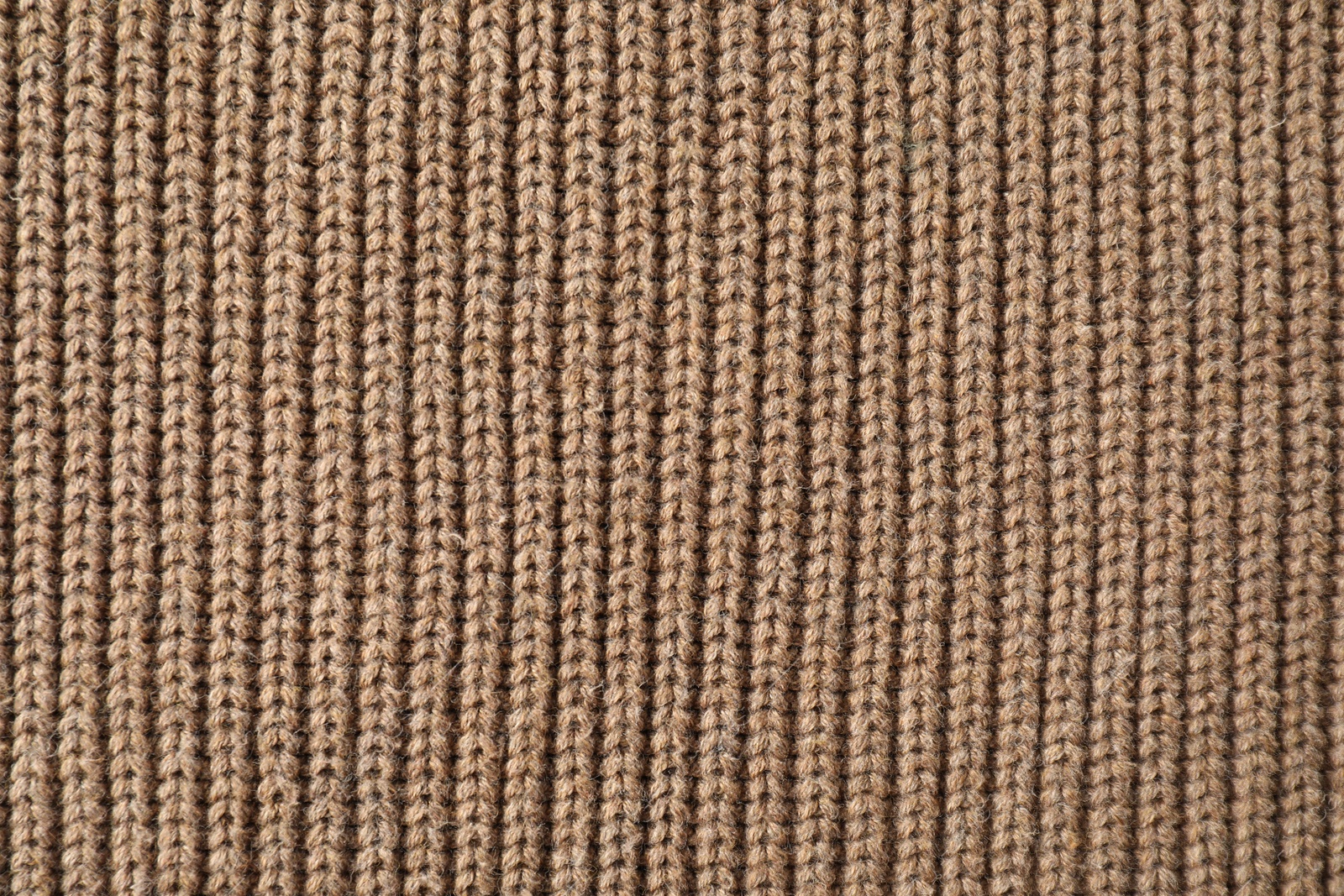 Photo of Texture of brown knitted fabric as background, top view