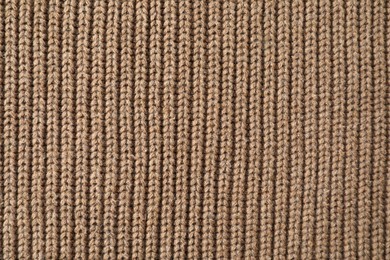 Photo of Texture of brown knitted fabric as background, top view