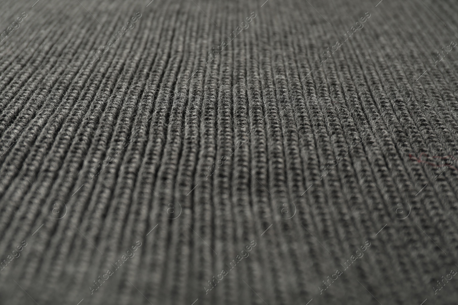 Photo of Texture of grey knitted fabric as background, closeup