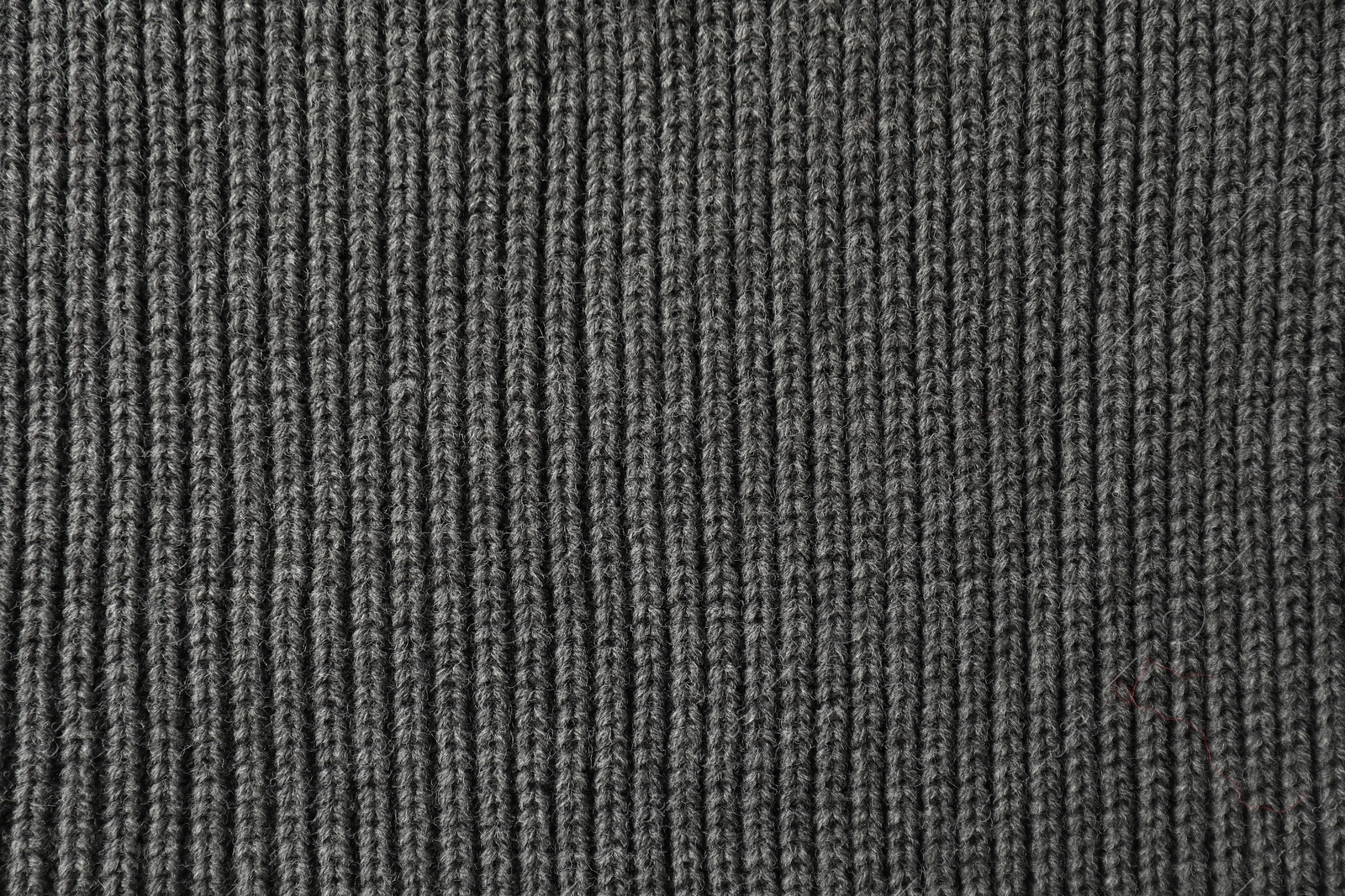 Photo of Texture of grey knitted fabric as background, top view