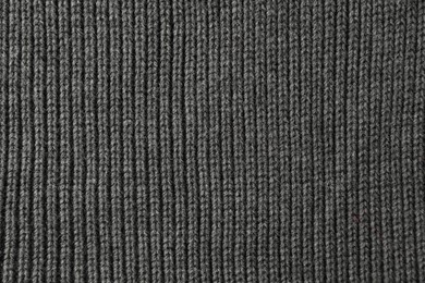 Photo of Texture of grey knitted fabric as background, top view