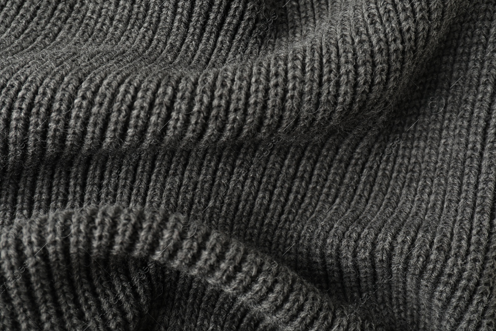 Photo of Texture of grey knitted fabric as background, top view