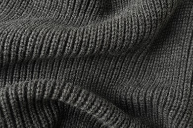 Photo of Texture of grey knitted fabric as background, top view