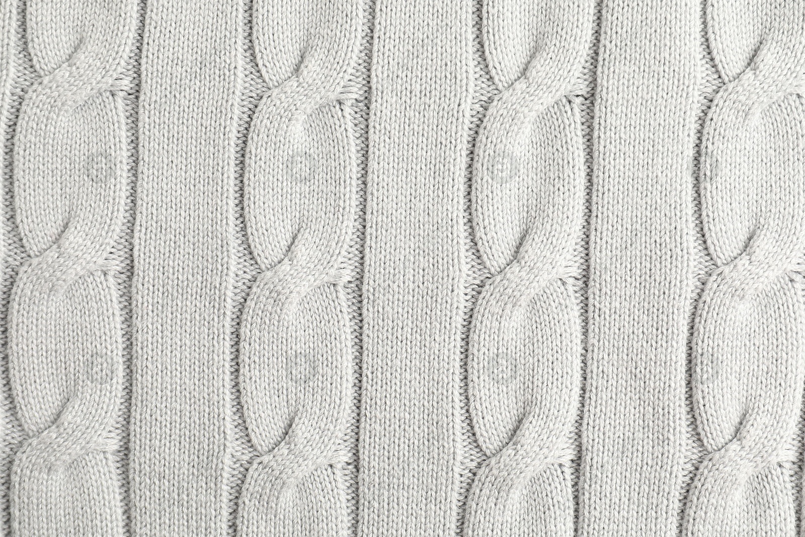 Photo of Texture of white knitted fabric as background, top view