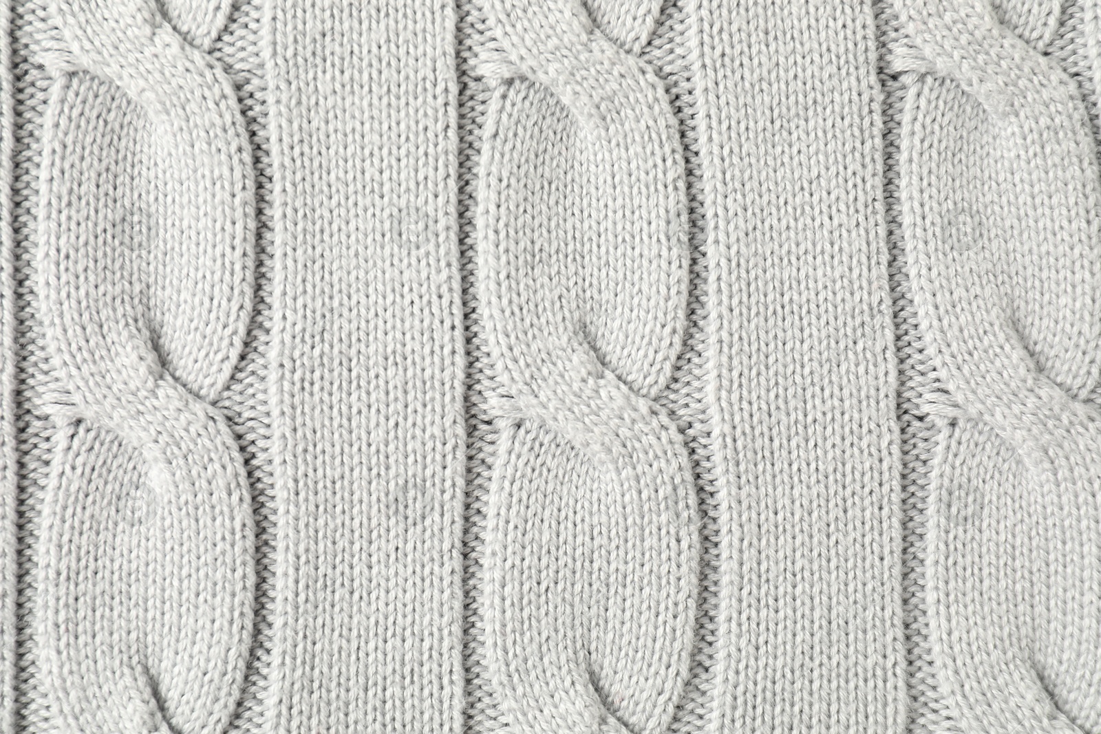 Photo of Texture of white knitted fabric as background, top view