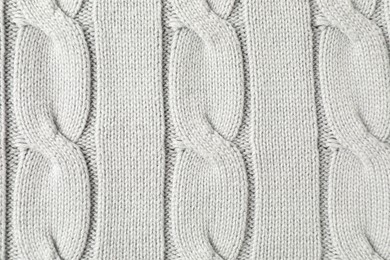 Texture of white knitted fabric as background, top view