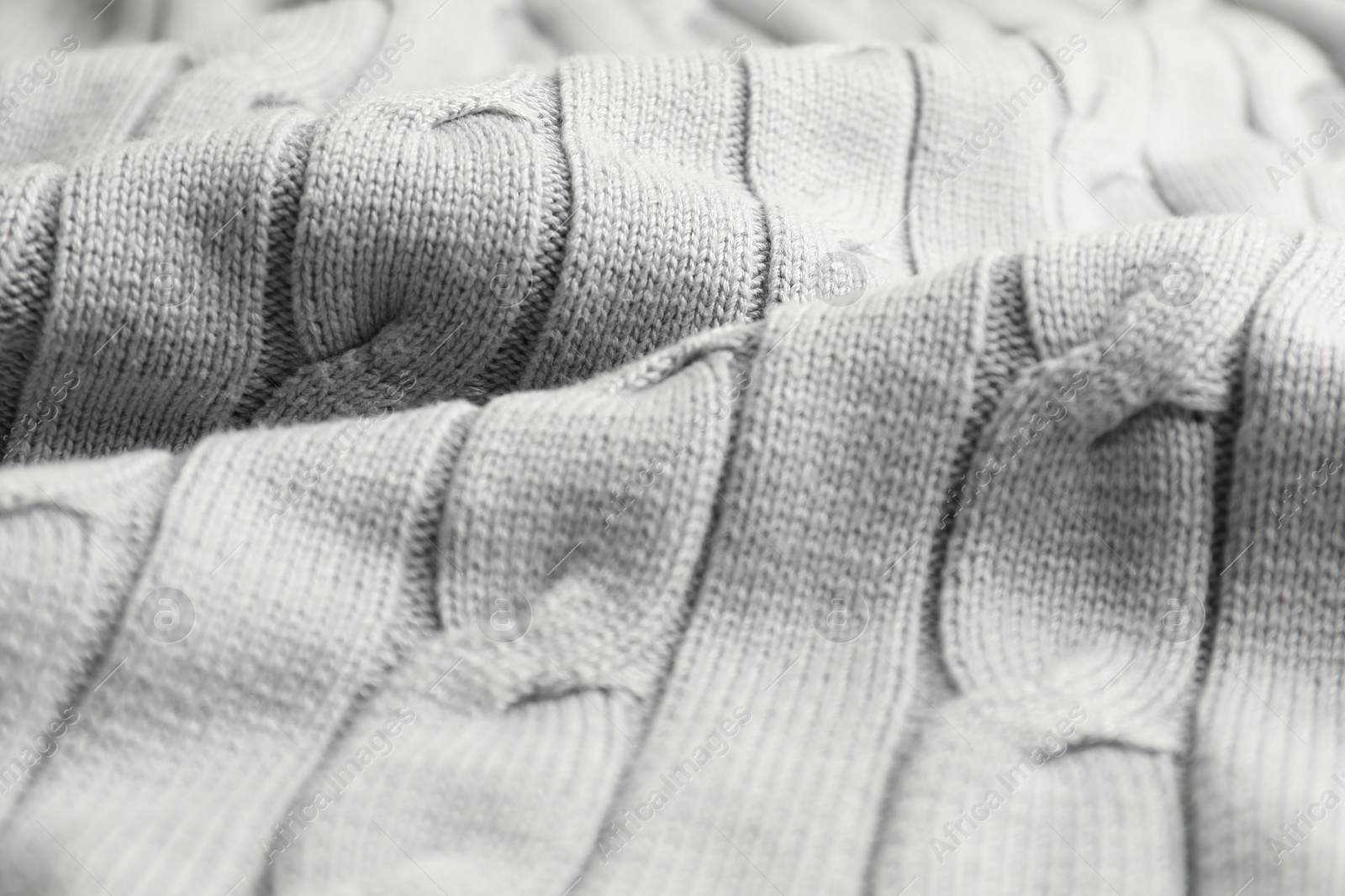 Photo of Texture of white knitted fabric as background, closeup