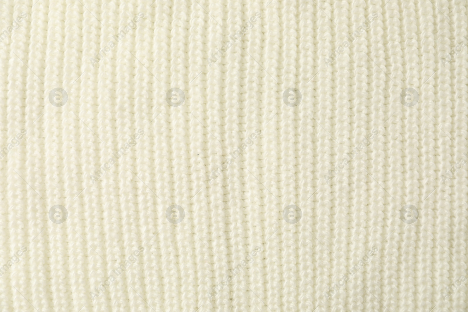 Photo of Texture of white knitted fabric as background, top view