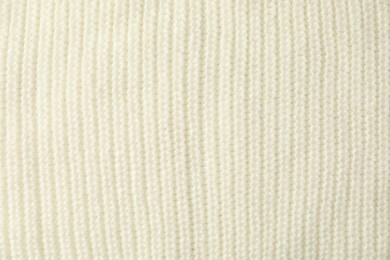 Photo of Texture of white knitted fabric as background, top view