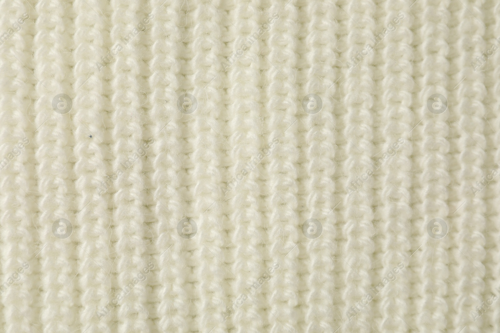 Photo of Texture of white knitted fabric as background, top view