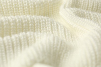 Texture of white knitted fabric as background, closeup