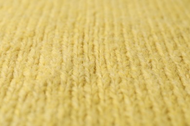 Texture of yellow knitted fabric as background, closeup