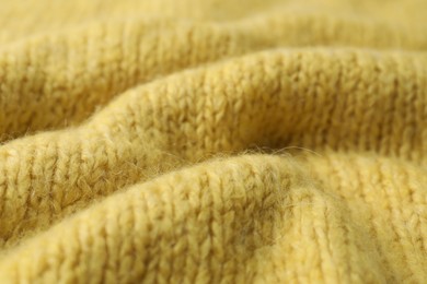 Photo of Texture of yellow knitted fabric as background, closeup