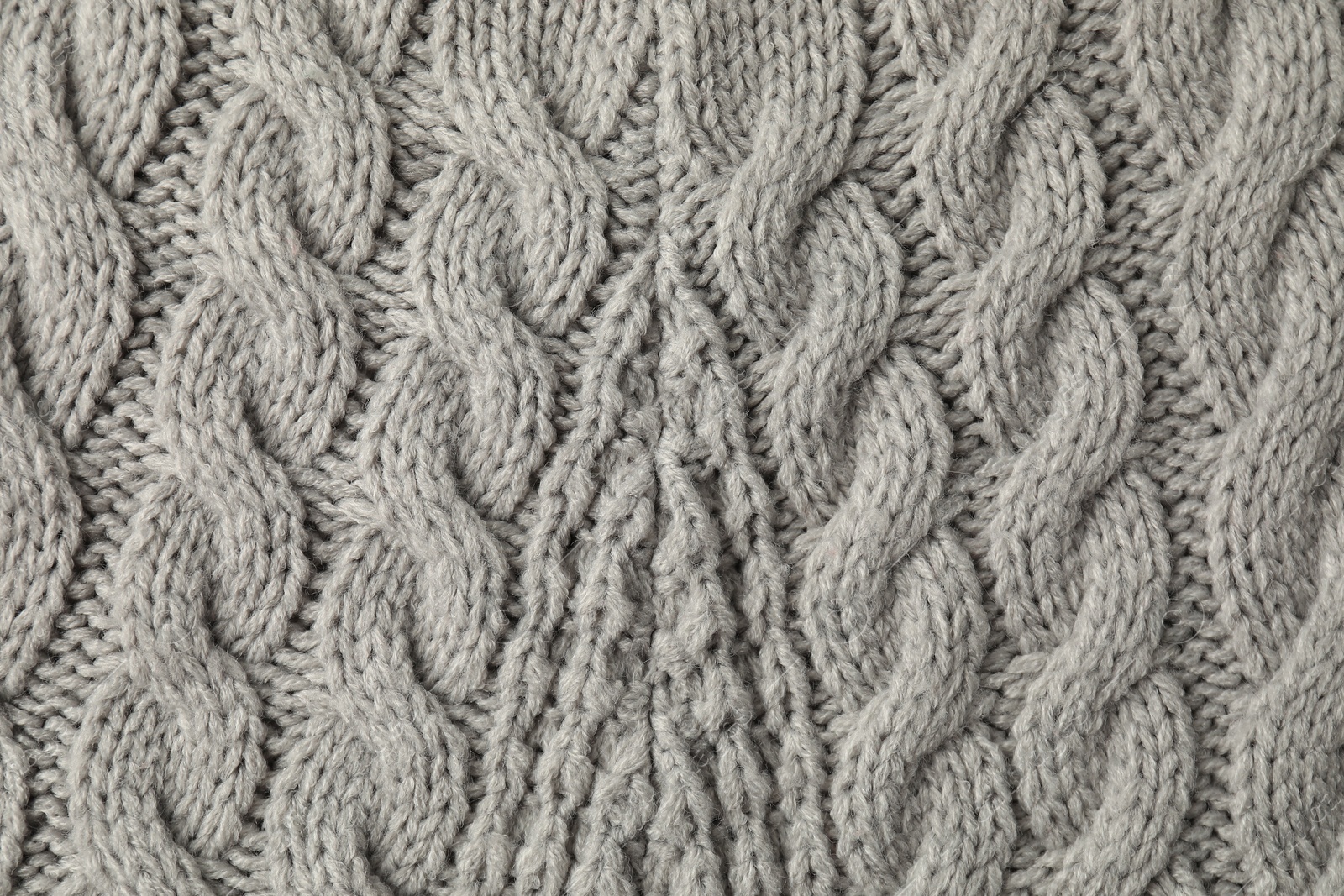 Photo of Texture of grey knitted fabric as background, top view