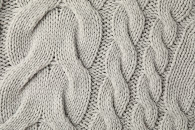 Photo of Texture of grey knitted fabric as background, top view