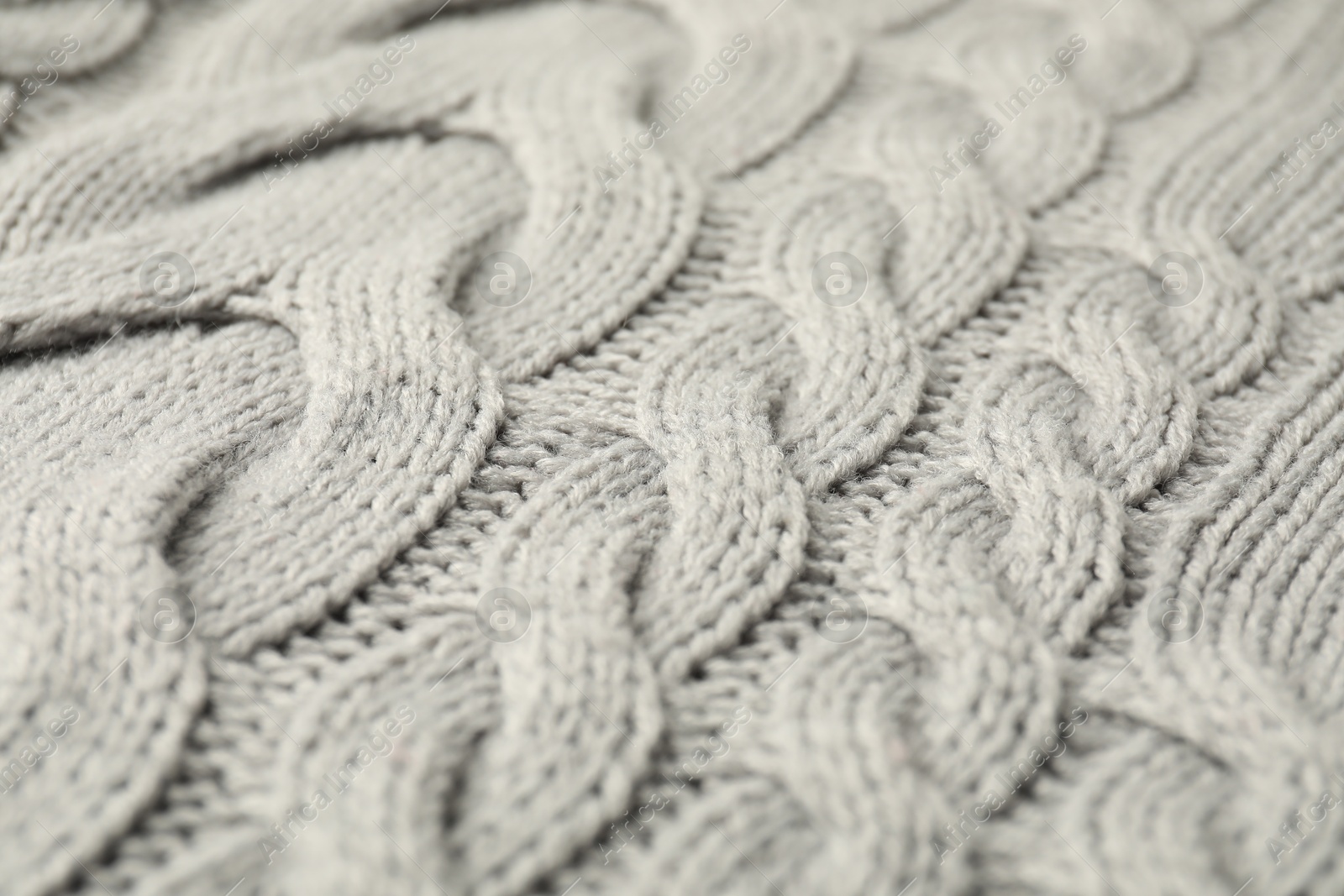 Photo of Texture of grey knitted fabric as background, closeup