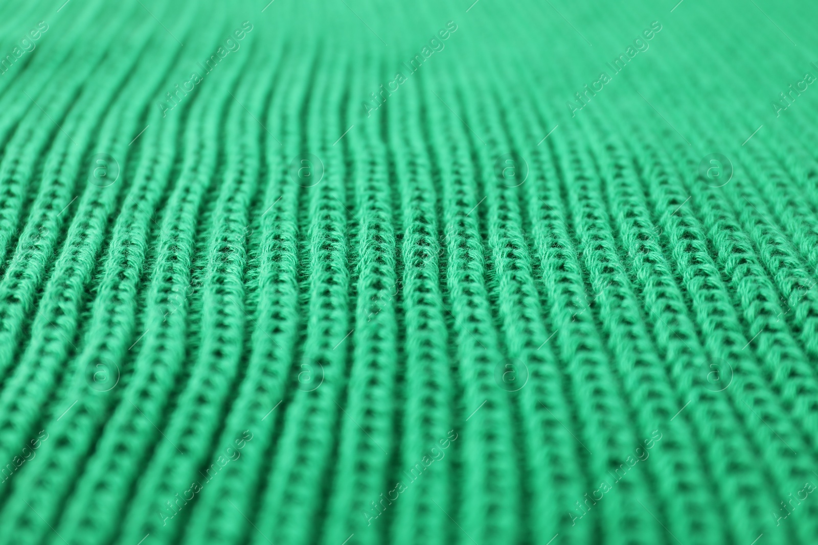 Photo of Texture of green knitted fabric as background, closeup