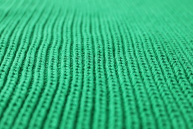 Texture of green knitted fabric as background, closeup