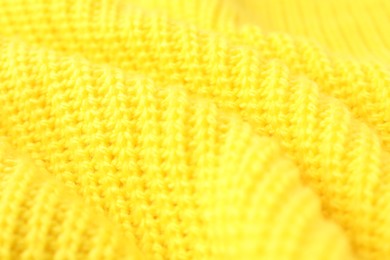 Photo of Texture of yellow knitted fabric as background, closeup