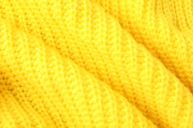 Texture of yellow knitted fabric as background, closeup