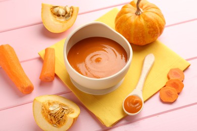 Photo of Delicious baby food in bowl and fresh ingredients on pink wooden table