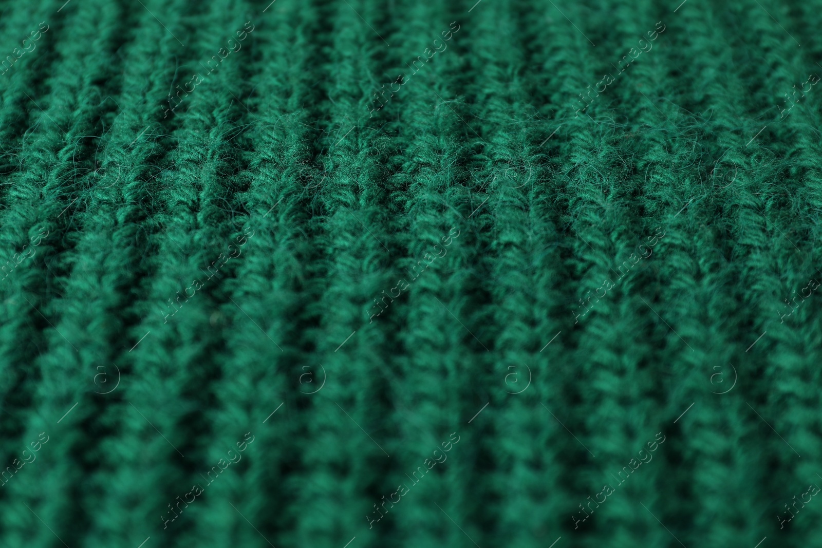 Photo of Texture of green knitted fabric as background, closeup