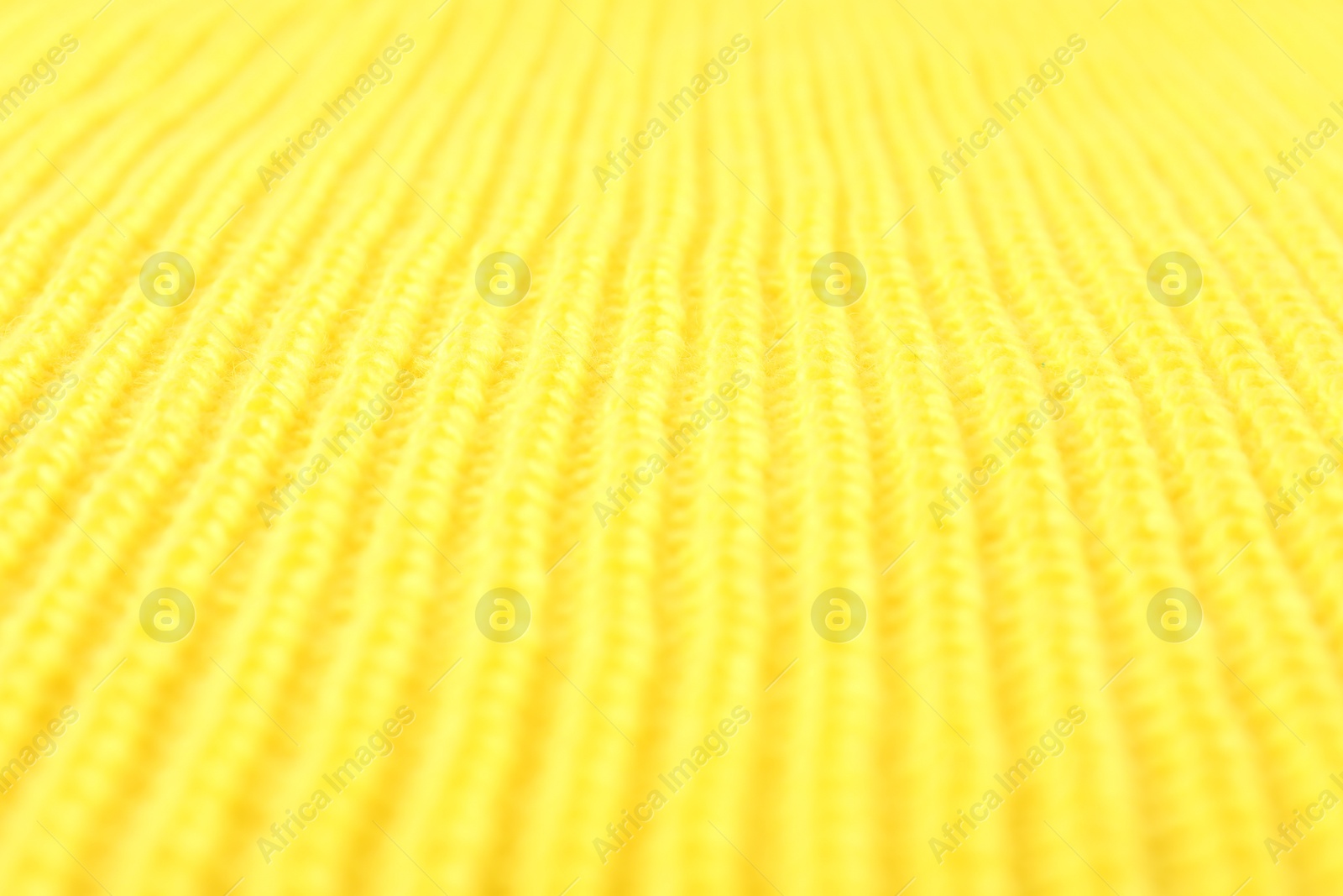 Photo of Texture of yellow knitted fabric as background, closeup