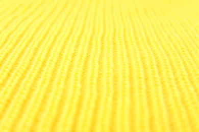 Photo of Texture of yellow knitted fabric as background, closeup