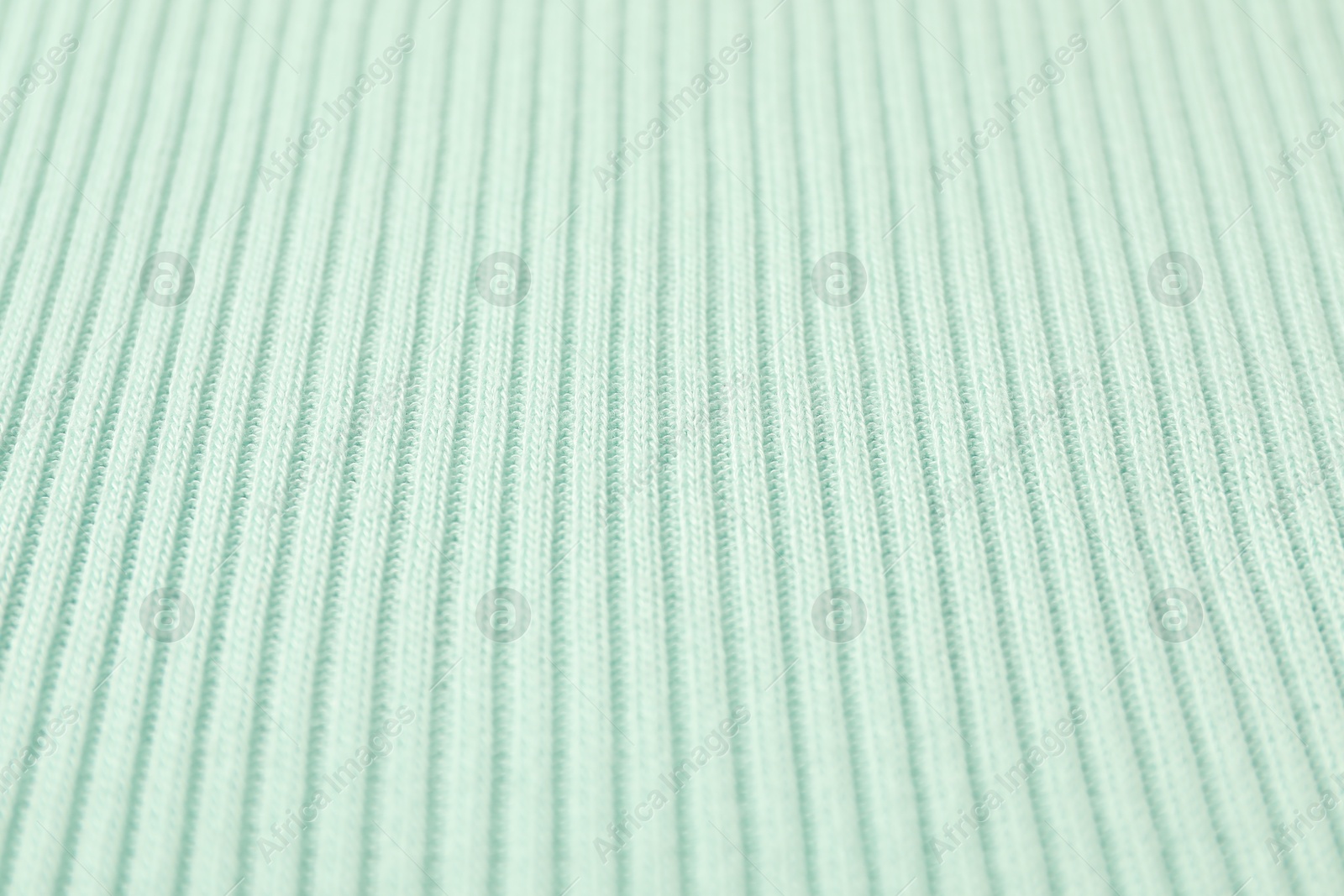 Photo of Texture of light blue knitted fabric as background, closeup