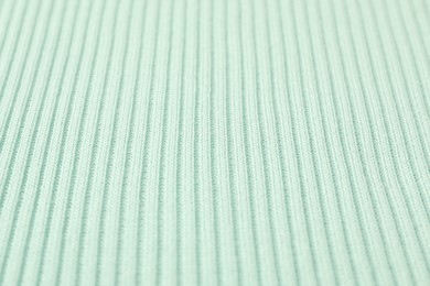 Texture of light blue knitted fabric as background, closeup