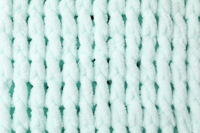 Texture of light blue knitted fabric as background, top view