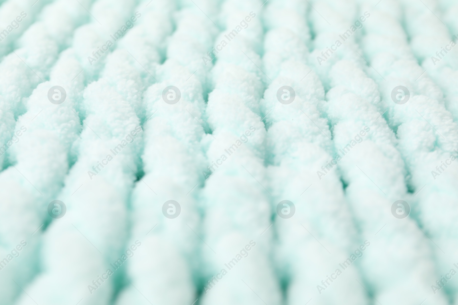 Photo of Texture of light blue knitted fabric as background, closeup