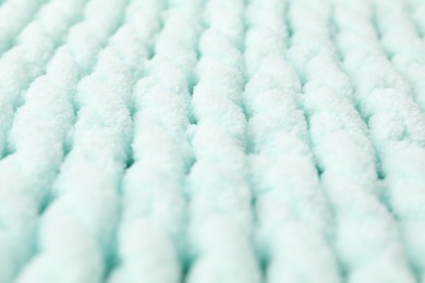 Texture of light blue knitted fabric as background, closeup