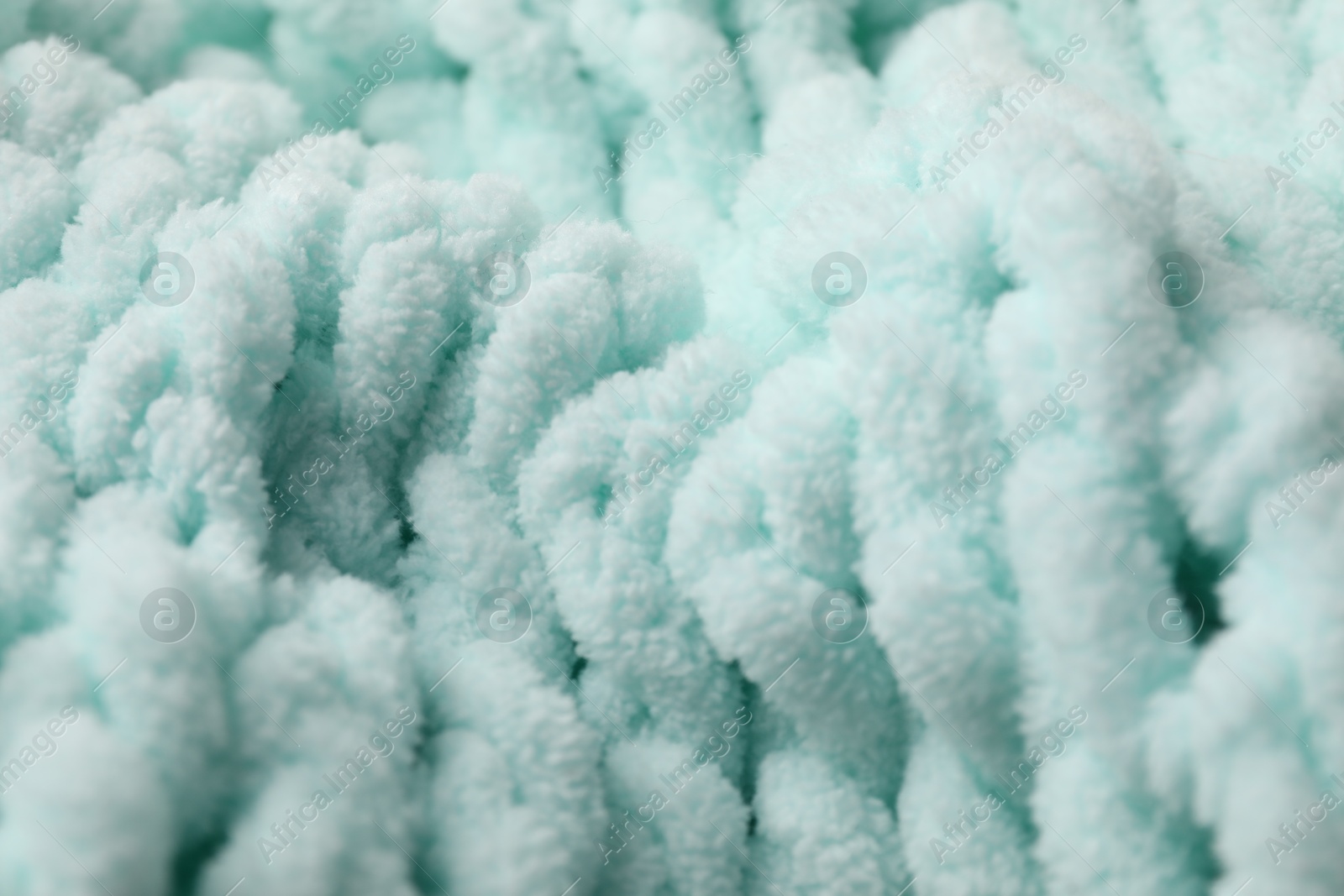 Photo of Texture of light blue knitted fabric as background, closeup