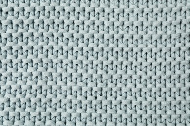 Texture of light blue knitted fabric as background, top view