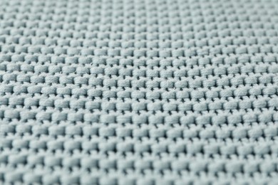 Photo of Texture of light blue knitted fabric as background, closeup