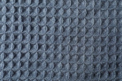 Photo of Texture of blue knitted fabric as background, top view