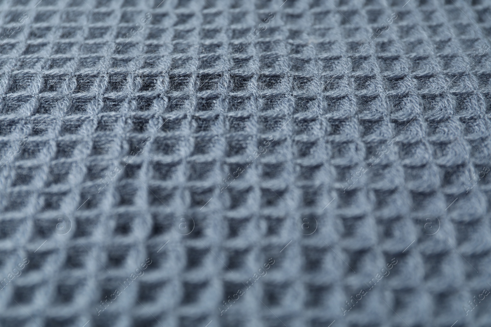 Photo of Texture of blue knitted fabric as background, closeup