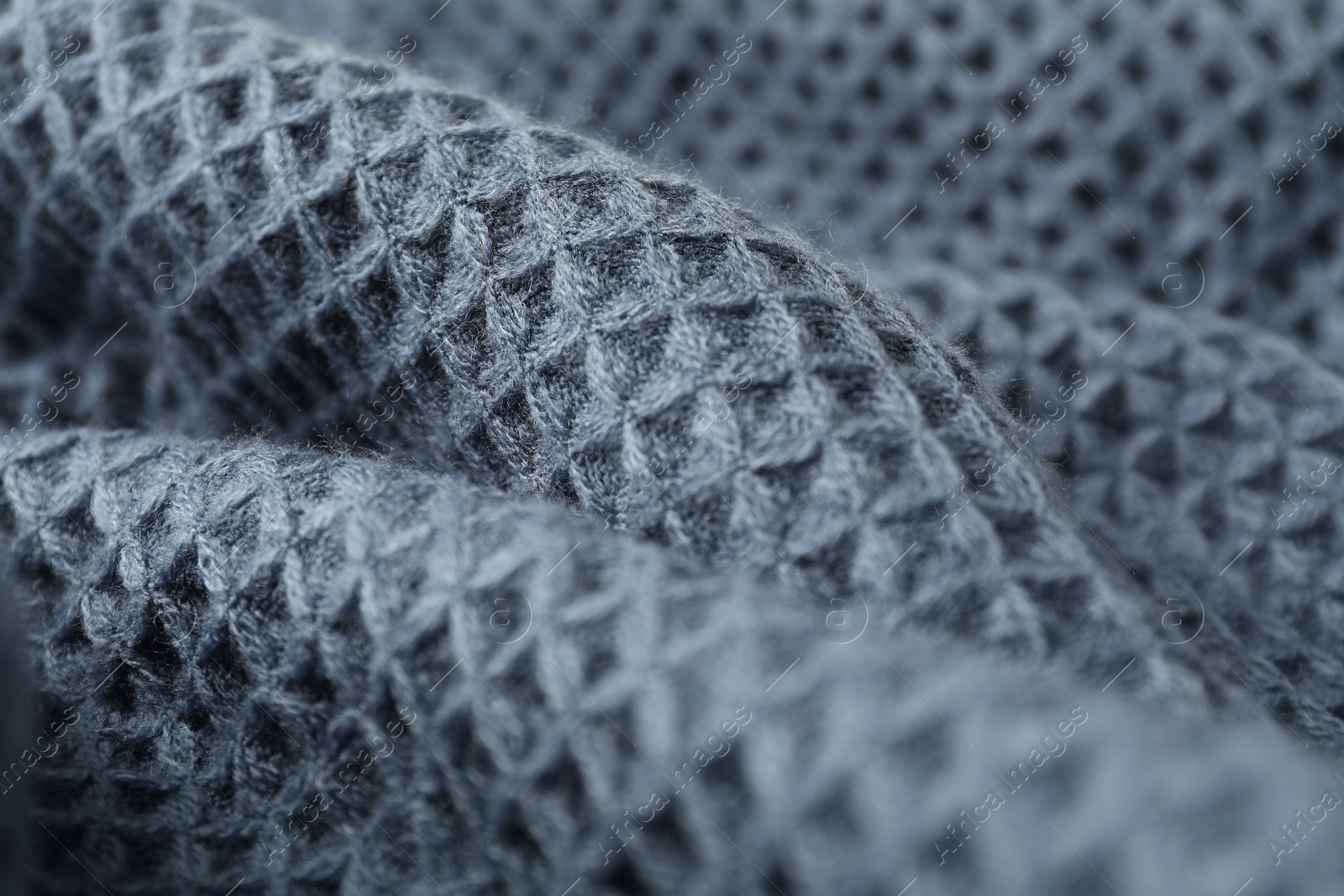 Photo of Texture of blue knitted fabric as background, closeup